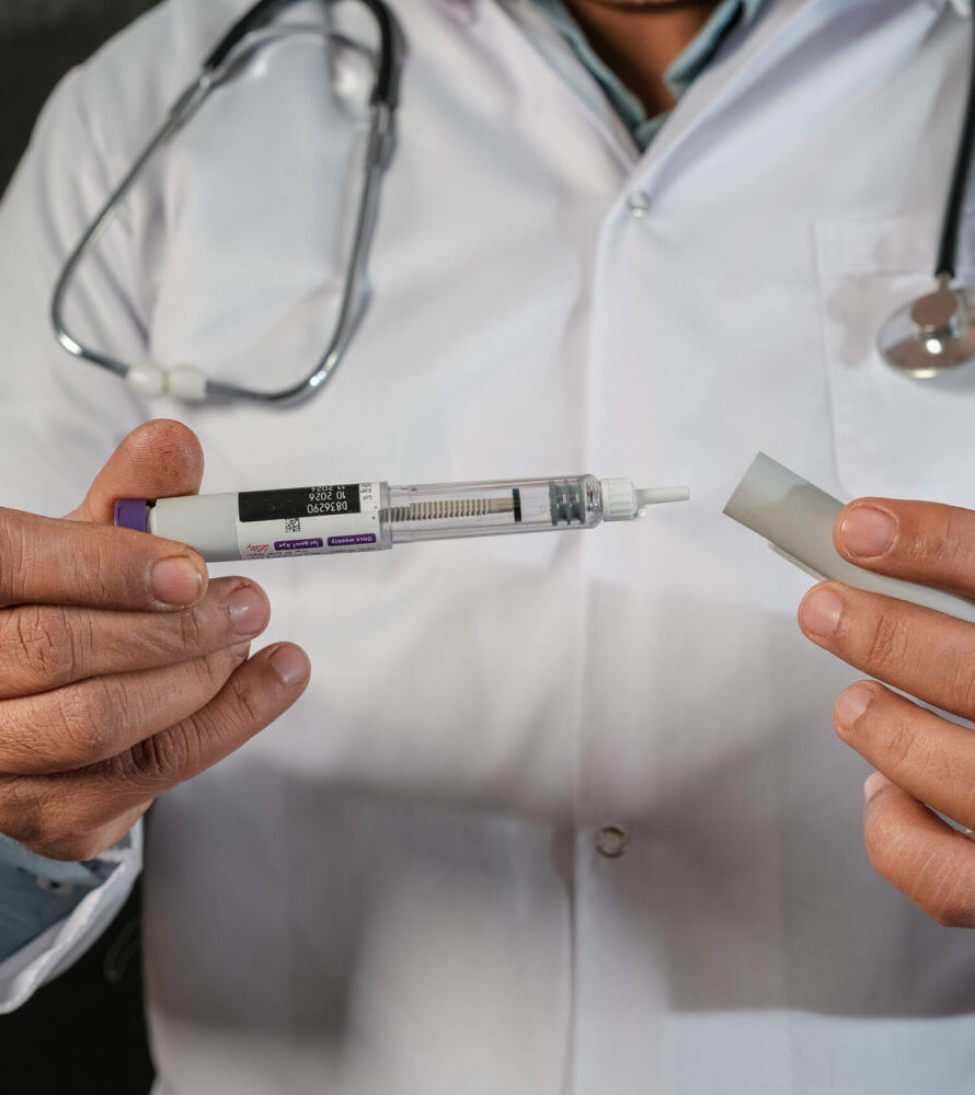 doctor presenting Mounjaro medication pen